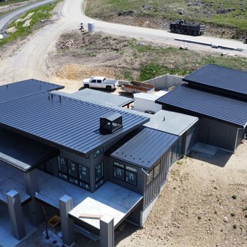 Black standing-seam metal roofs on modern new-construction homes