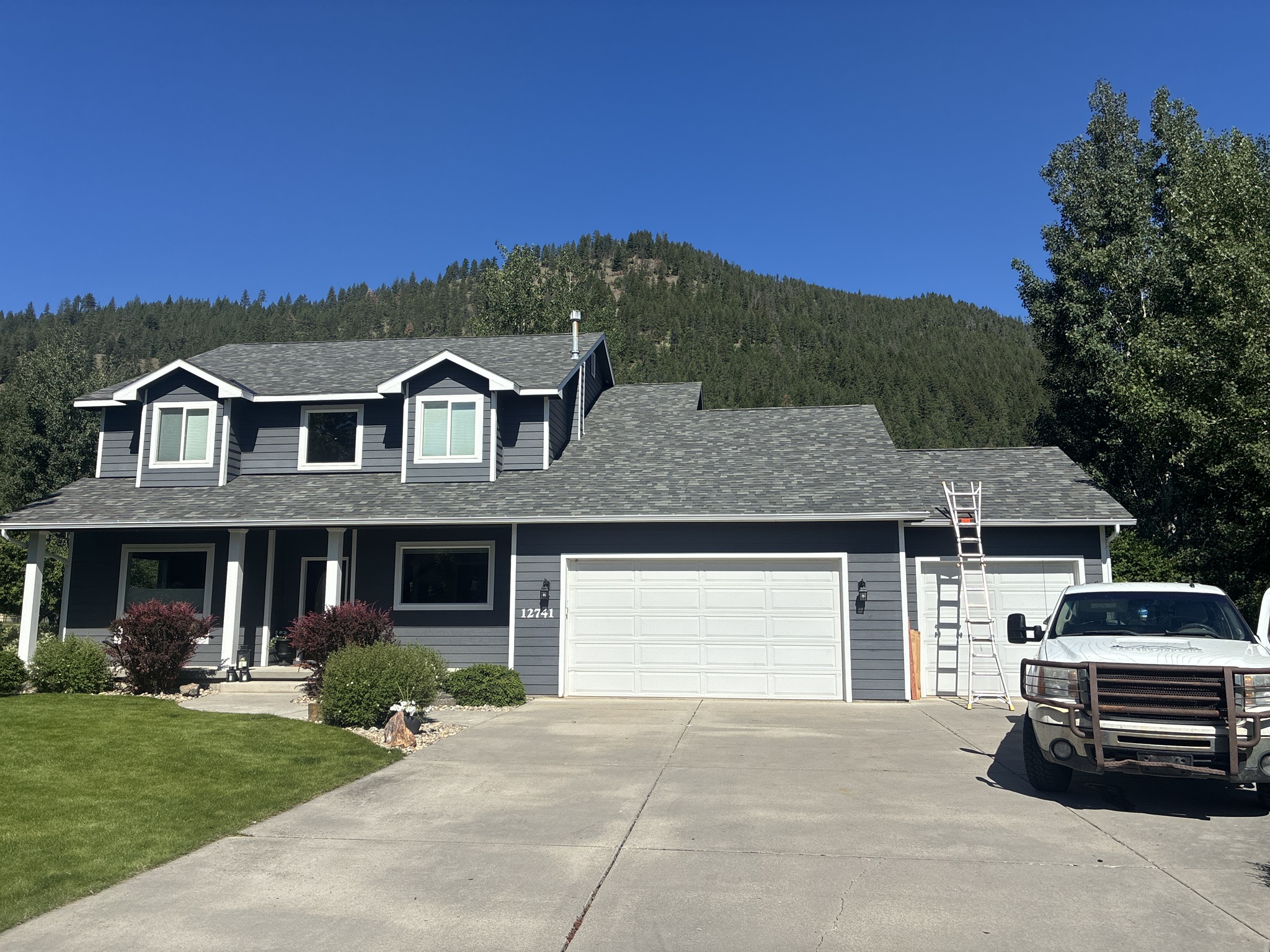 A Yellowstone Roofing residential roofing project in progress with a ladder at the eaves